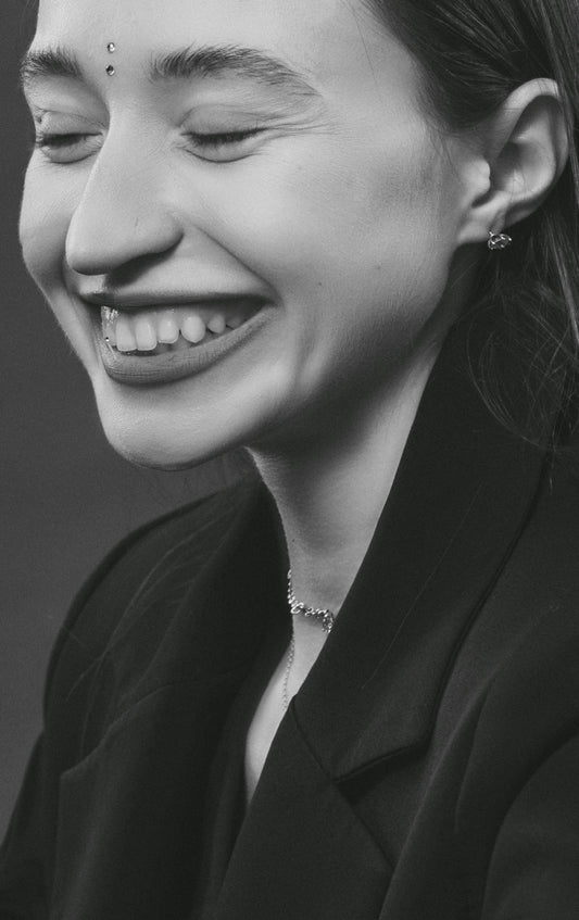 a black and white photo of a woman smiling